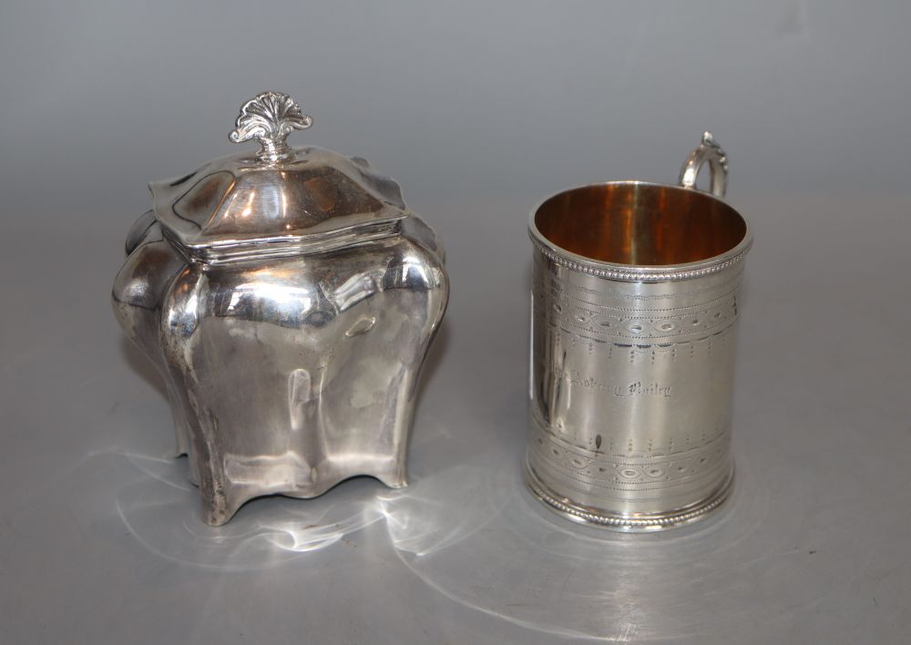 A Victorian engraved silver christening mug, Henry Holland, London, 1870 and an Edwardian silver tea caddy